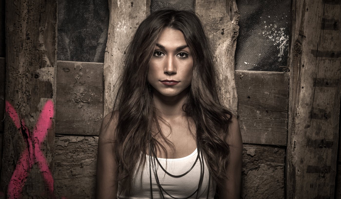 Portrait d’une femme devant une porte en bois
